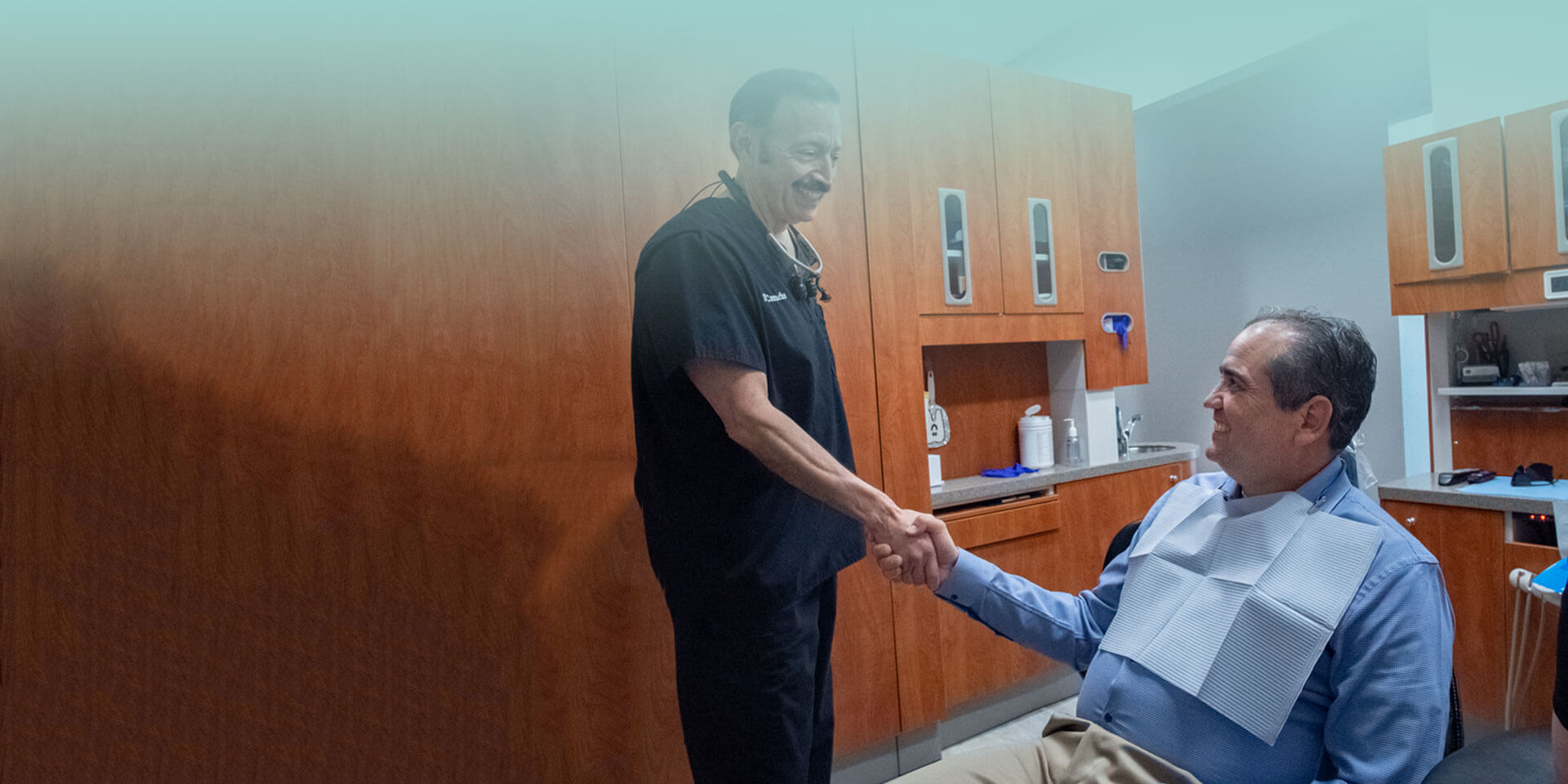 Dr. Edward Camacho shaking hands with patient